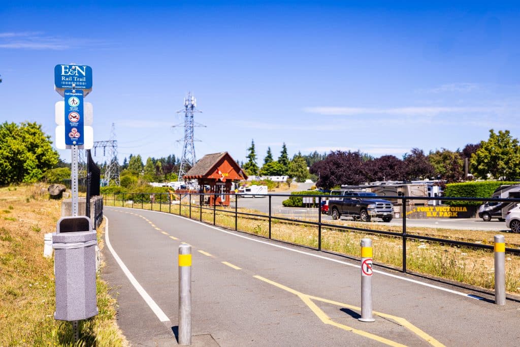 Paved roadway leading into Fort Victoria RV Park with entrance pavilion in the background