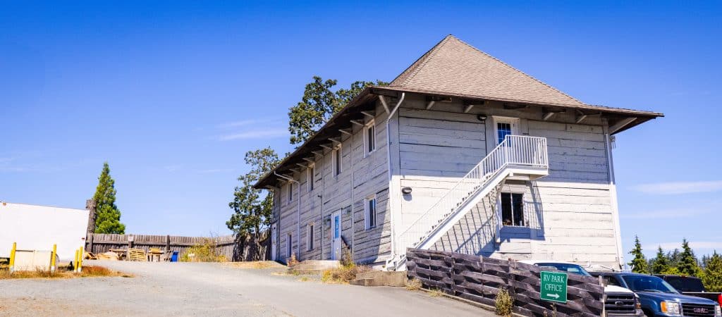 Grey wooden historic building at Fort Victoria RV Campground