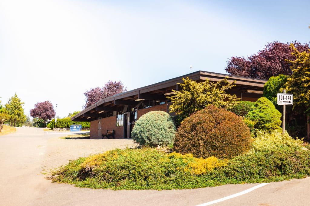 Exterior view of the clubhouse and landscaped gardens at Fort Victoria RV Campground
