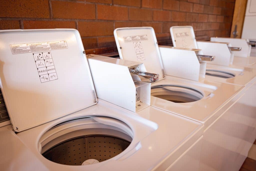 Row of top-load washing machines in the laundry facility at Fort Victoria RV Park