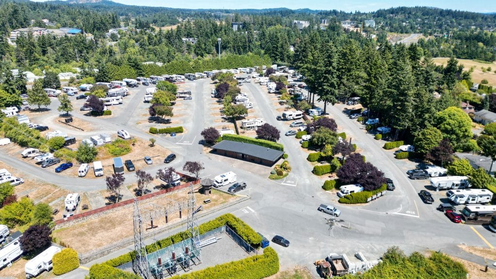 Entrance road at Fort Victoria RV Park with RVs lined up at the check-in station.