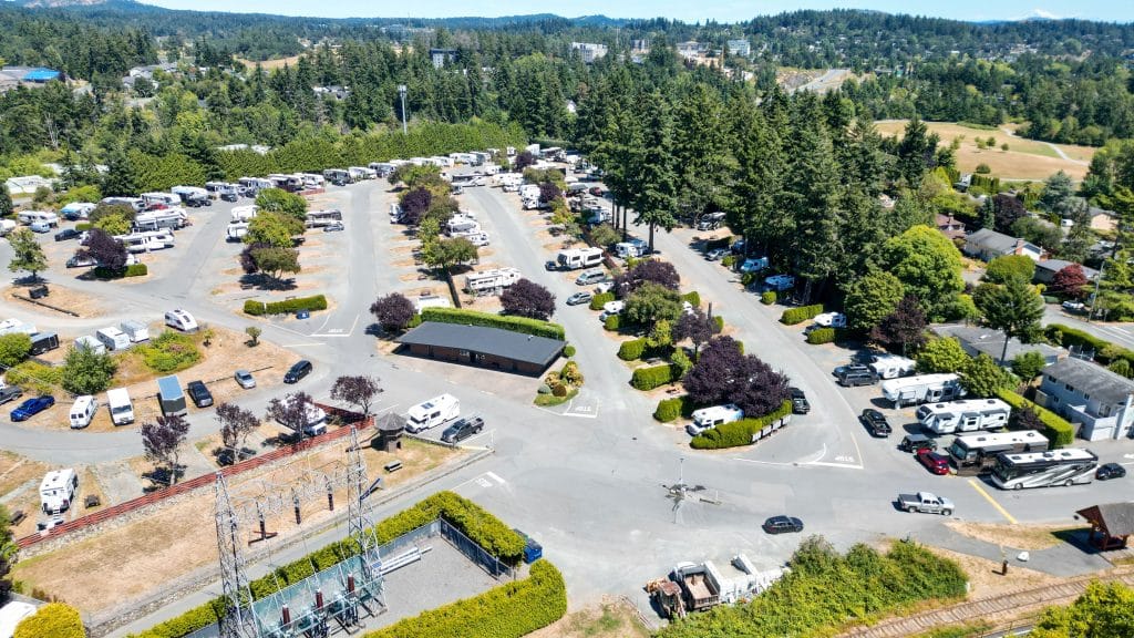 Wide drone photo of Fort Victoria RV Park showing full layout of sites, roads, and trees.