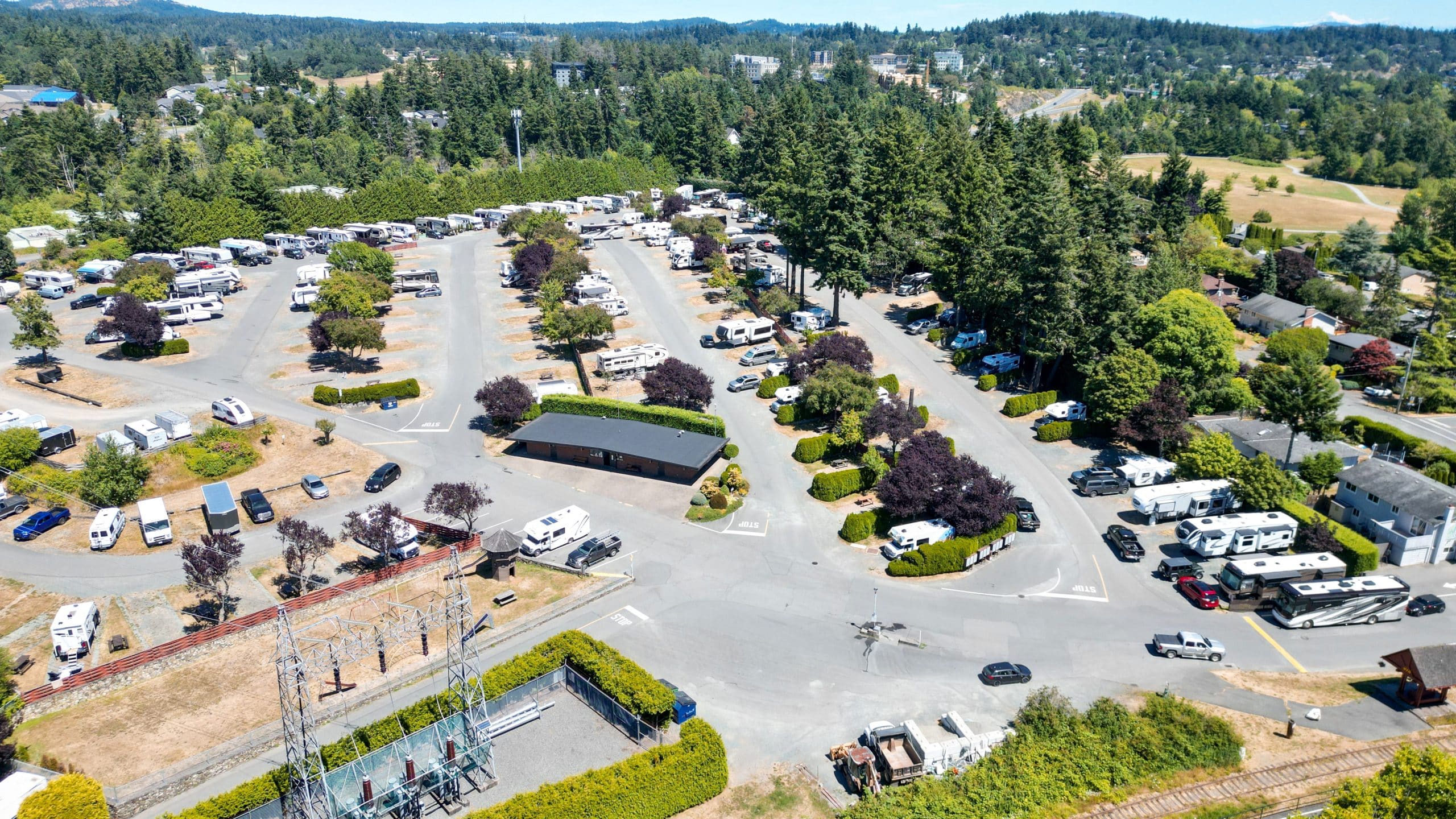 Wide drone photo of Fort Victoria RV Park showing full layout of sites, roads, and trees.