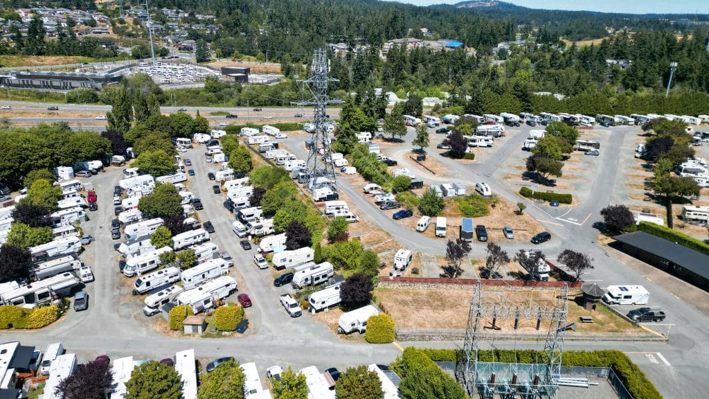 Aerial drone view of Fort Victoria RV Park showing rows of RV sites with hookups and tree cover.