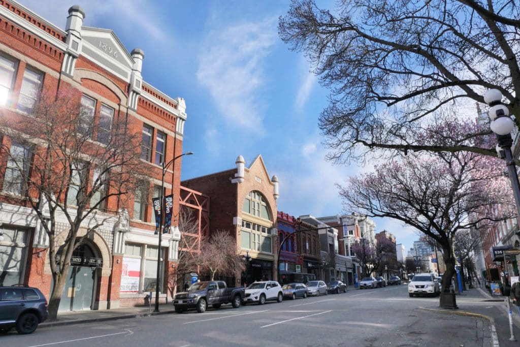 Street view of downtown Victoria with shops and restaurants.