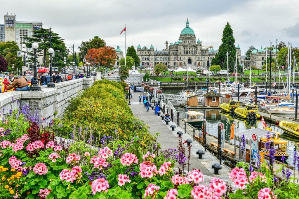 Boats docked at Victoria’s Inner Harbour with historic buildings.